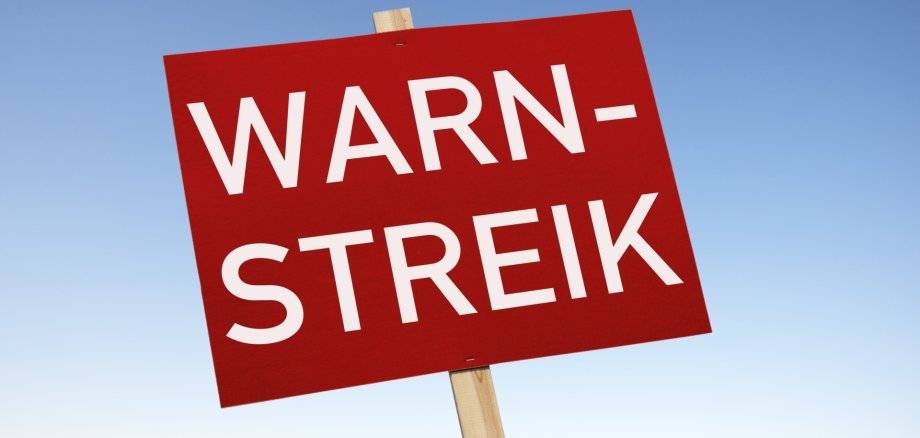 The photo shows a sign with the inscription "Warning strike".