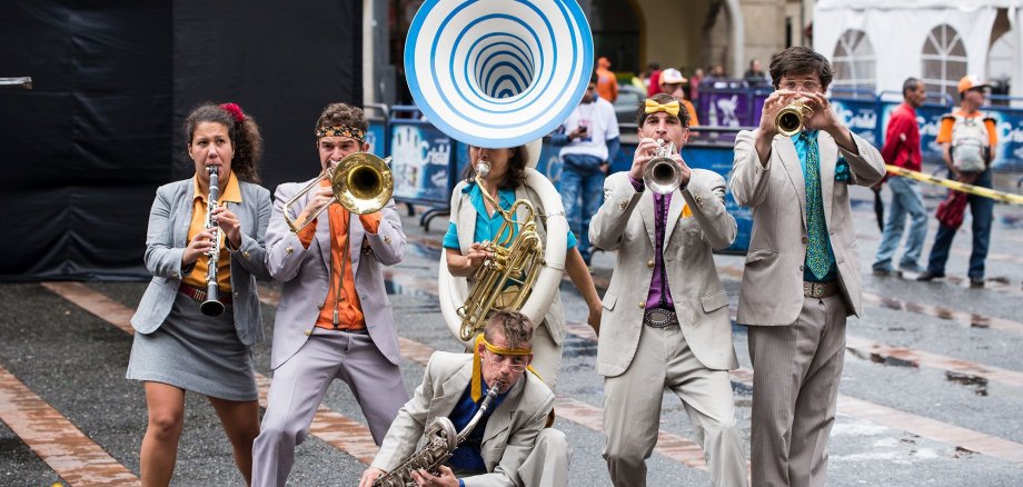 The photo shows the street theater band Calle Loca with their instruments.