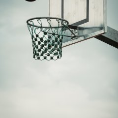 The photo shows a basketball flying into the basket.